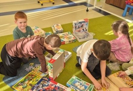 grupa dzieci przedszkolnych podczas segregowania gier i układanek obchodów Dnia Postaci z Bajek