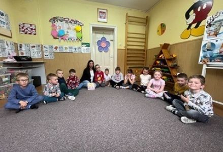 grupa dzieci przedszkolnych podczas głośnego czytania